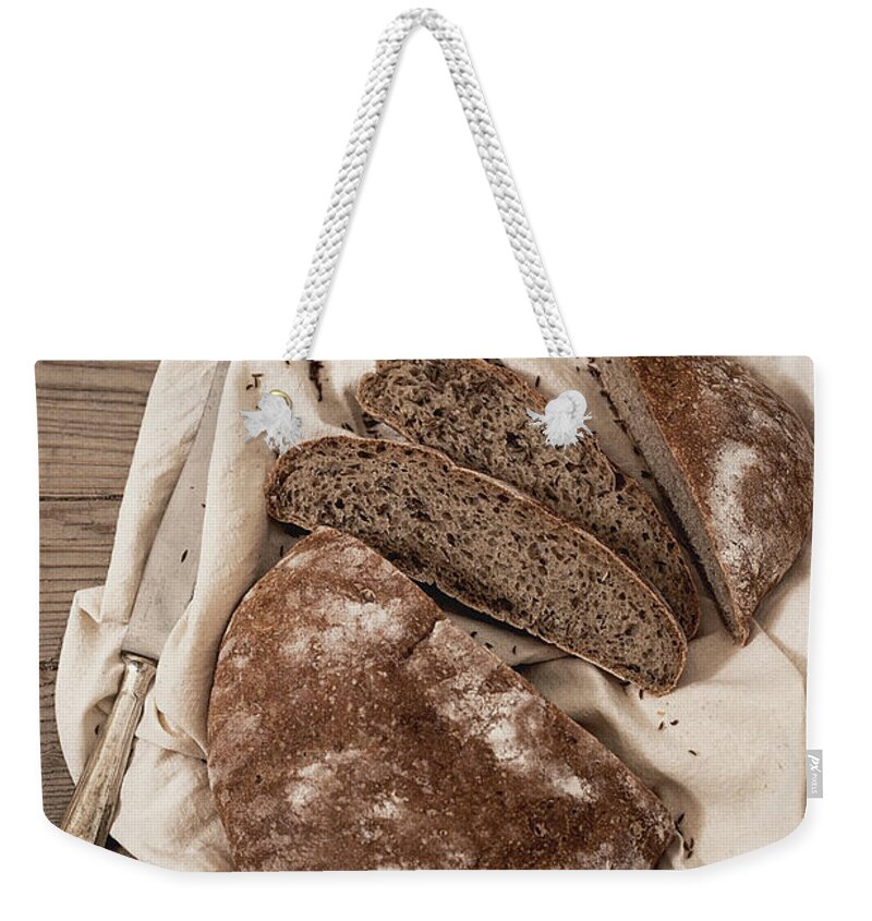 Belluno Weekender Tote Bag featuring the photograph Puccia Rye Bread With Cumin Seeds by One Girl In The Kitchen