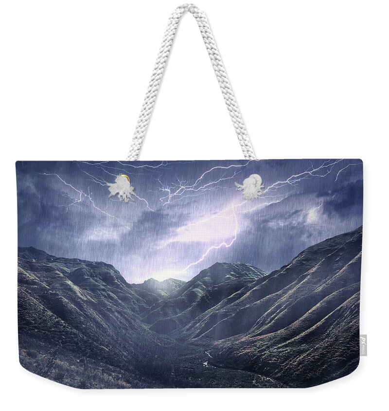 Environmental Conservation Weekender Tote Bag featuring the photograph Raging Over The Mountains by Yuri arcurs