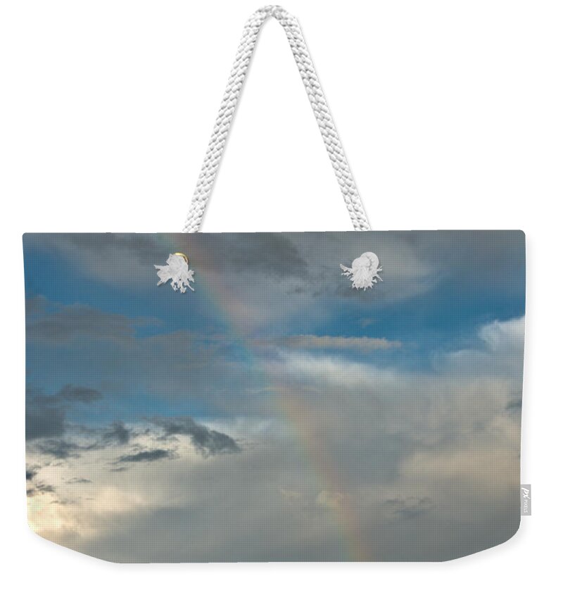 Rainbow Weekender Tote Bag featuring the photograph Rainbow through the clouds by Cheryl Baxter