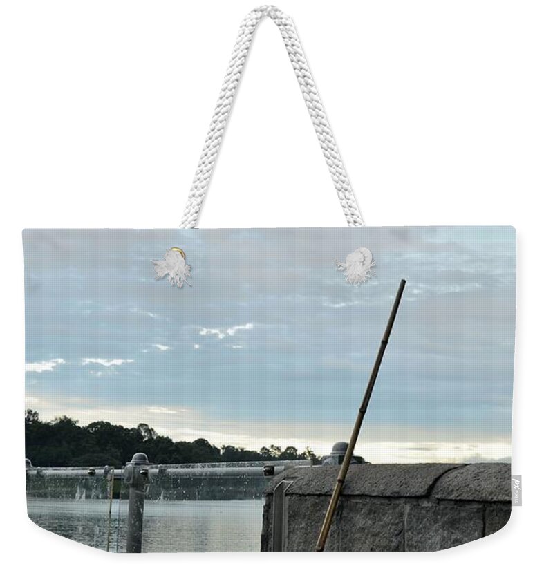 Rake Weekender Tote Bag featuring the photograph Rake rests itself after a hard days work by Imran Ahmed
