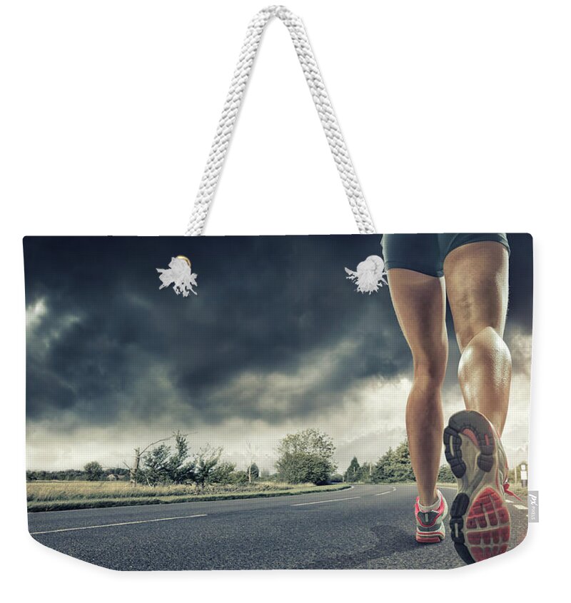 Recreational Pursuit Weekender Tote Bag featuring the photograph Rear View Of Runners Legs by Peepo