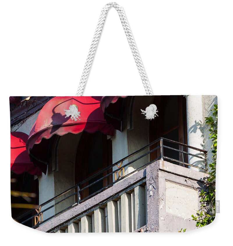 1924 Weekender Tote Bag featuring the photograph Red Awnings at the Van Dyke by Ed Gleichman