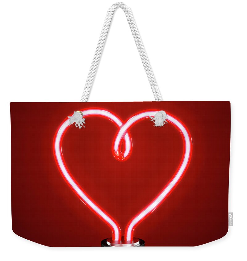 Black Background Weekender Tote Bag featuring the photograph Red Heart Shaped Energy Saving Lightbulb by Atomic Imagery