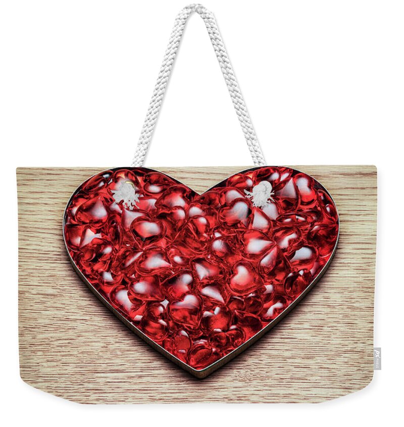 Large Group Of Objects Weekender Tote Bag featuring the photograph Red Hearts In A Heart Shape by Jonathan Kitchen
