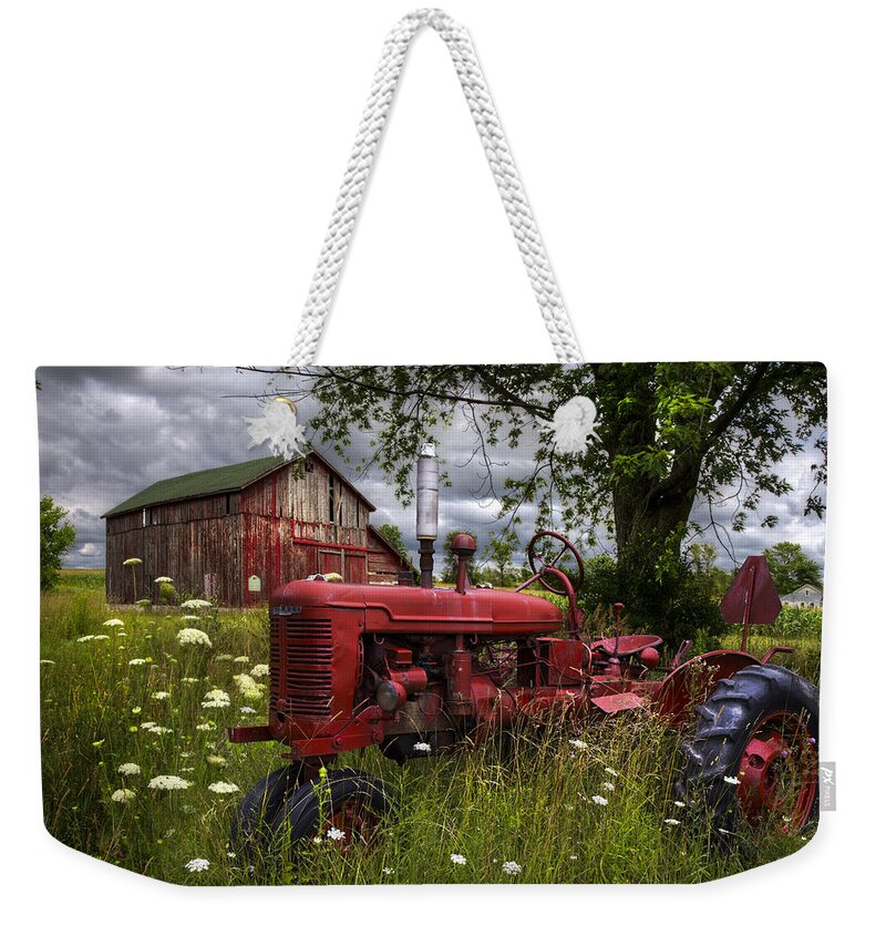 Tractor Weekender Tote Bag featuring the photograph Reds in the Pasture by Debra and Dave Vanderlaan