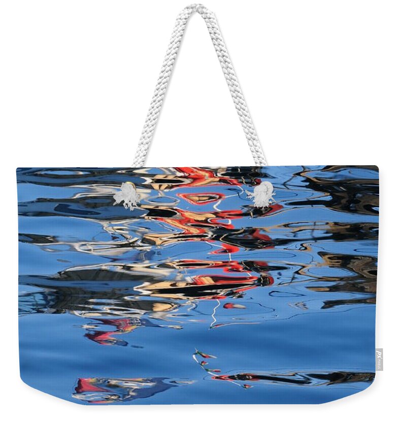 Water Reflections Red Weekender Tote Bag featuring the photograph Reflections in red by Susie Rieple