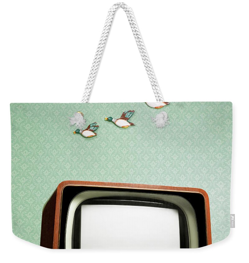 Humor Weekender Tote Bag featuring the photograph Retro Tv With Flying Ducks On The Wall by Peter Dazeley