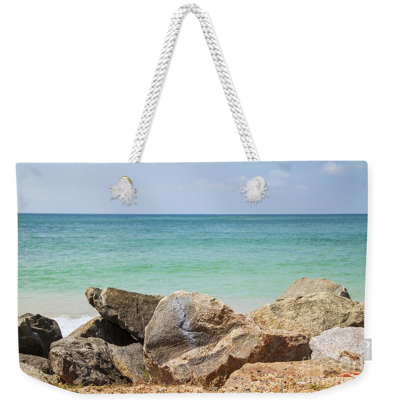 Indian Ocean Weekender Tote Bag featuring the photograph rocks in front of the Indian Ocean by Gina Koch