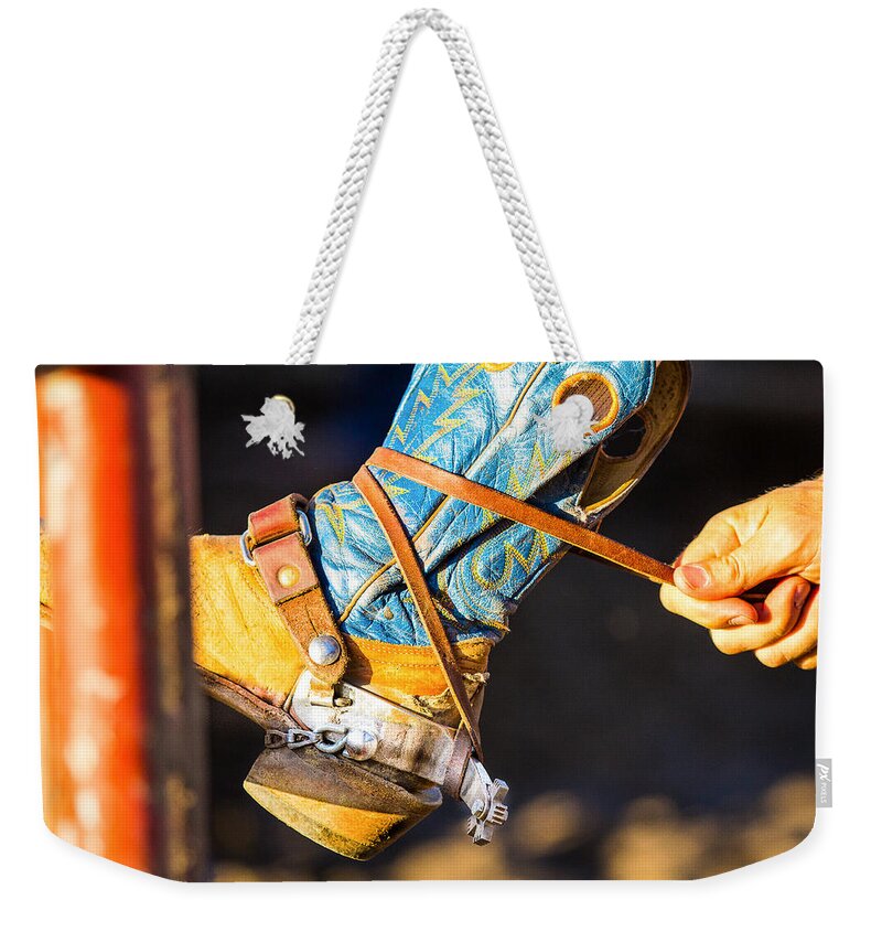 Steven Bateson Weekender Tote Bag featuring the photograph Rodeo Boot Tie Down by Steven Bateson
