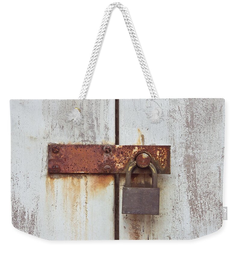 Aged Weekender Tote Bag featuring the photograph Rusty lock by Tom Gowanlock