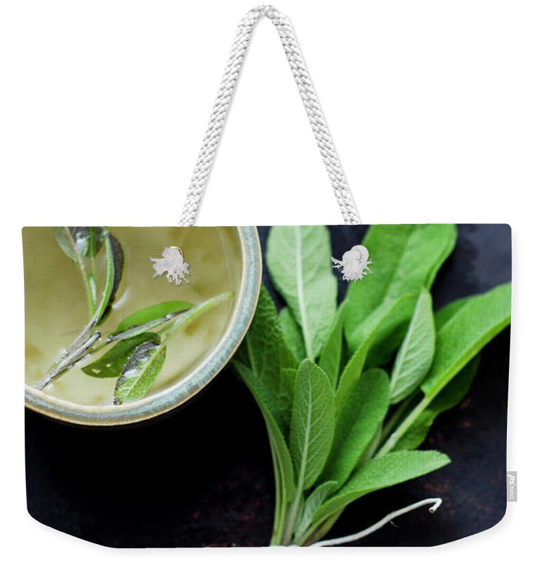Spice Weekender Tote Bag featuring the photograph Sage Tea In Small Cup With Bunch Of by Westend61