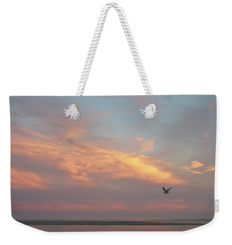 Tranquility Weekender Tote Bag featuring the photograph Seagull In Flight At Sunset by Joseph Shields