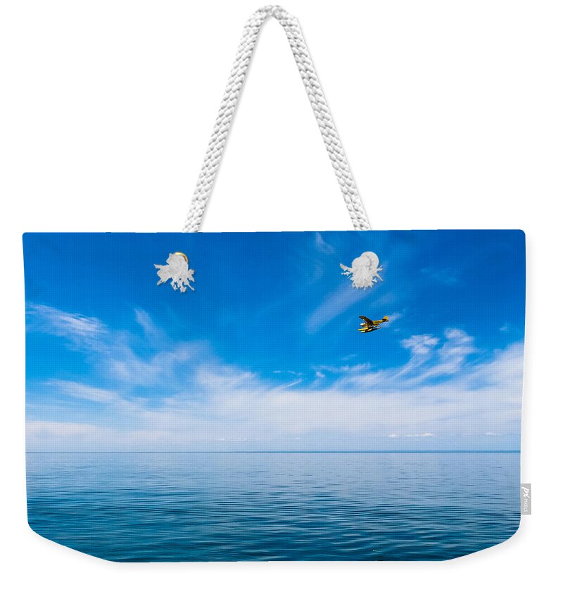 Michigan Weekender Tote Bag featuring the photograph Seaplane Over Lake Superior  by Lars Lentz