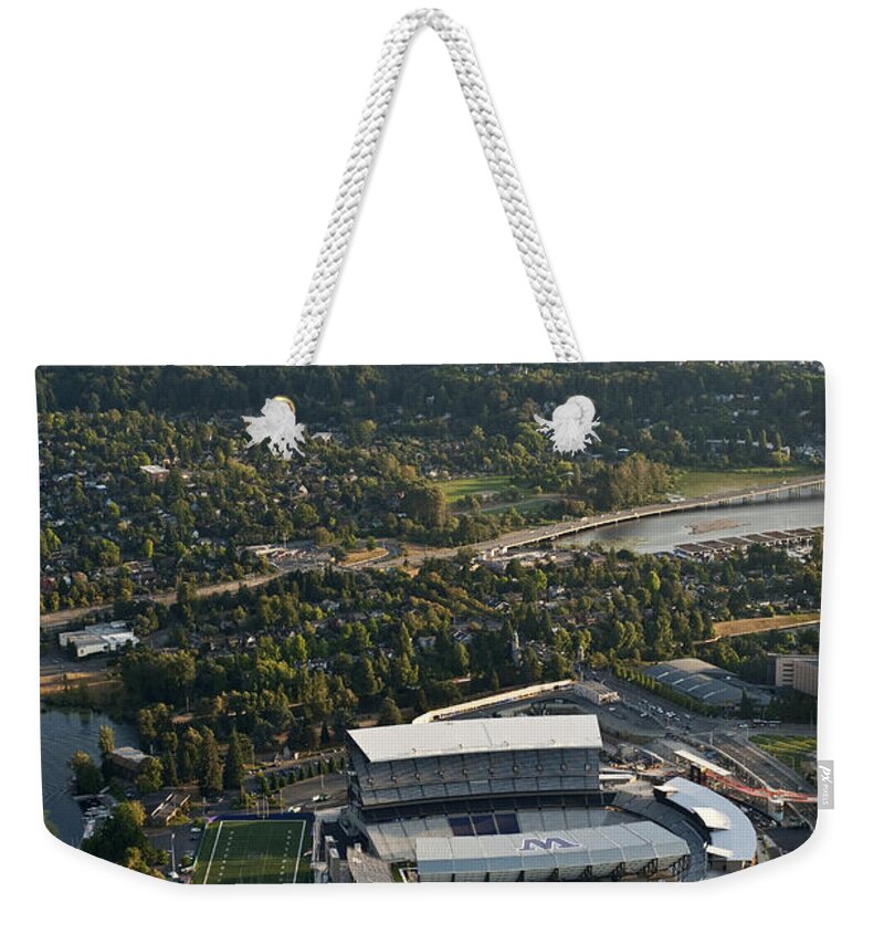 Elliott Bay Weekender Tote Bag featuring the photograph Seattle Skyline With Aerial Of Husky St by Jim Corwin