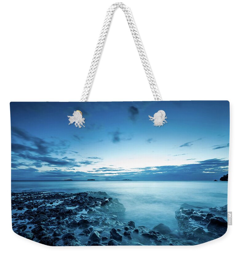 Tranquility Weekender Tote Bag featuring the photograph Serene Blue Beach by Jojo Nicdao