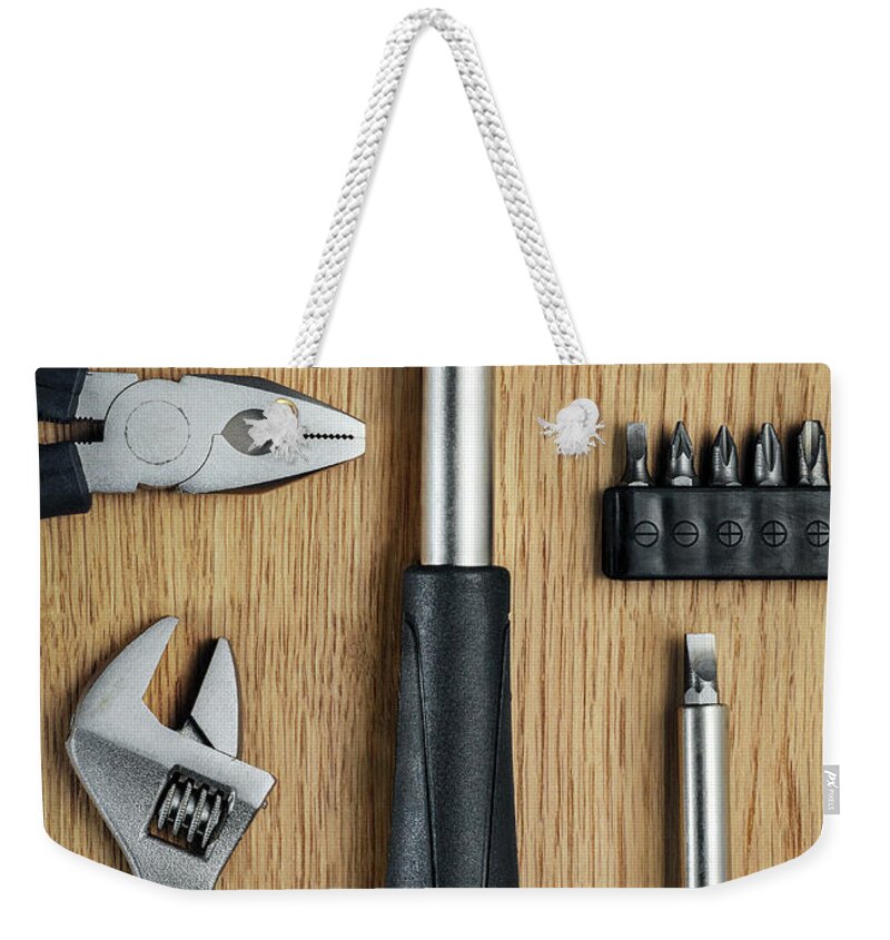 Work Tool Weekender Tote Bag featuring the photograph Set Of Tools by Jonathan Kitchen