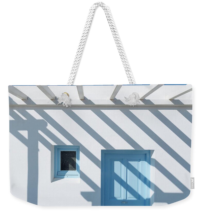 Shadow Weekender Tote Bag featuring the photograph Shadow On Traditional Greek House by Deimagine