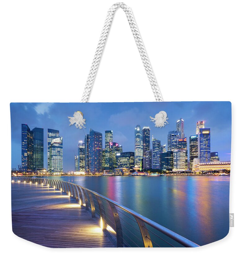 Corporate Business Weekender Tote Bag featuring the photograph Singapore Skyline Seen Over Marina Bay by Travelpix Ltd