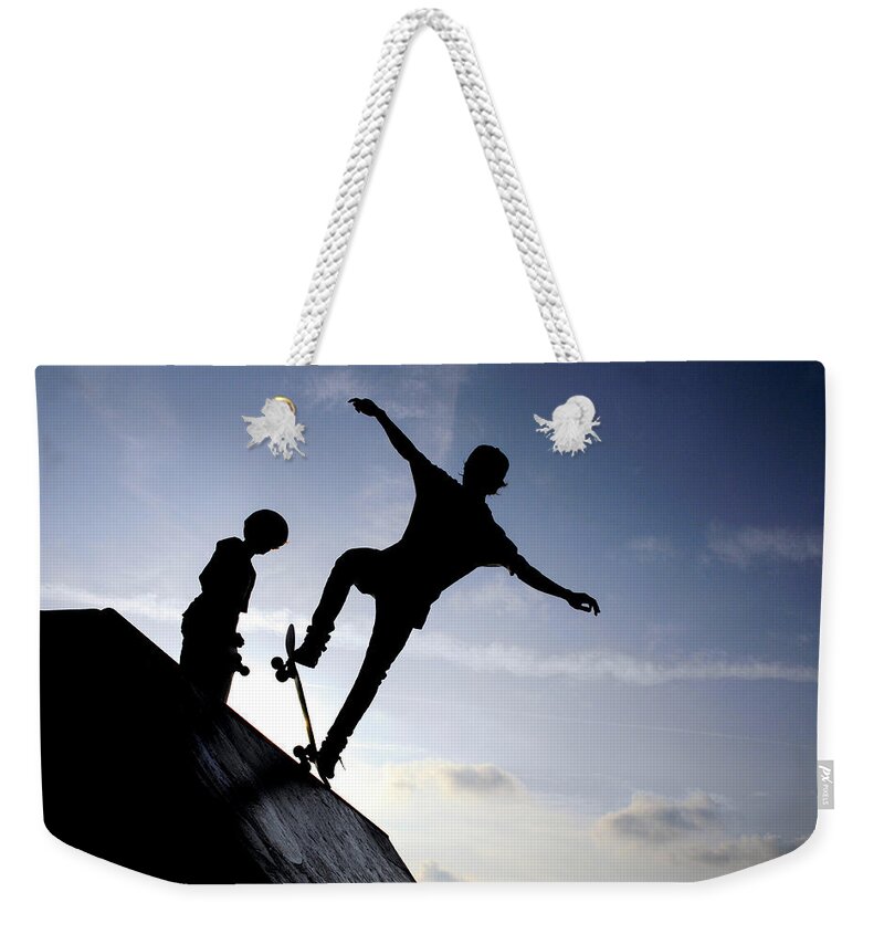 Skateboarders Weekender Tote Bag featuring the photograph Skateboarders by Fabrizio Troiani