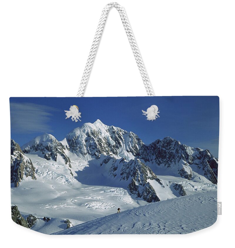 Feb0514 Weekender Tote Bag featuring the photograph Ski Mountaineer And Mt Tasman by Colin Monteath