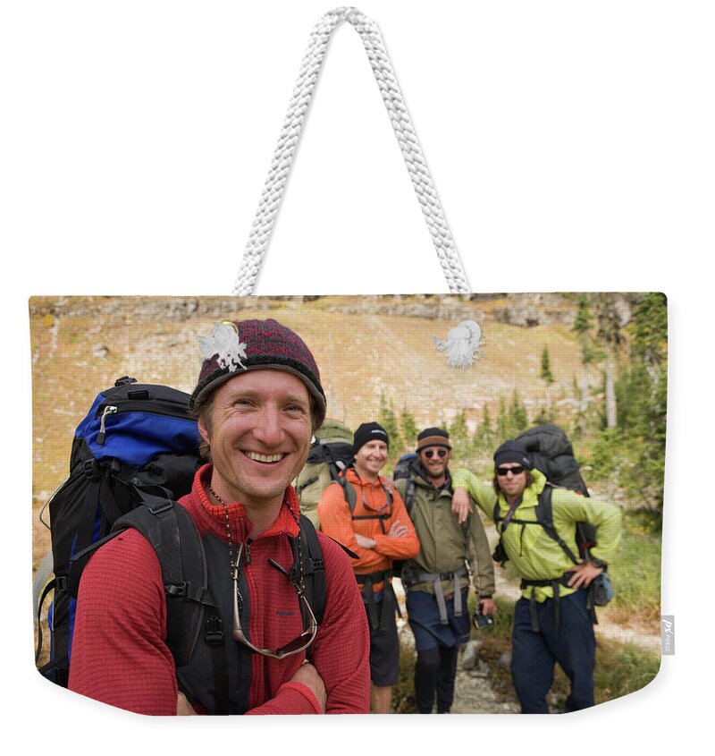 Adventure Weekender Tote Bag featuring the photograph Small Group Of Backpackers Take A Break by Heath Korvola