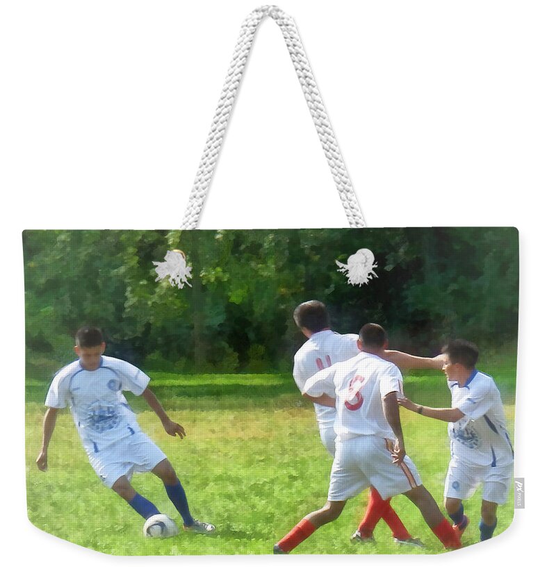 Outdoors Weekender Tote Bag featuring the photograph Soccer Ball in Play by Susan Savad