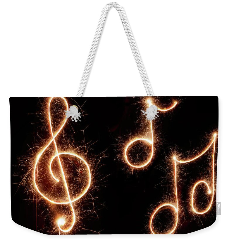 Light Painting Weekender Tote Bag featuring the photograph Sparkling Musical Symbols by Lauren Nicole