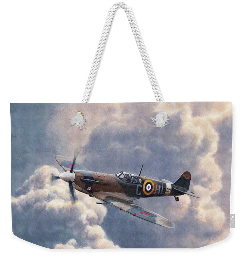Adult Weekender Tote Bag featuring the photograph Spitfire Plane Flying In Storm Cloud by Ikon Ikon Images