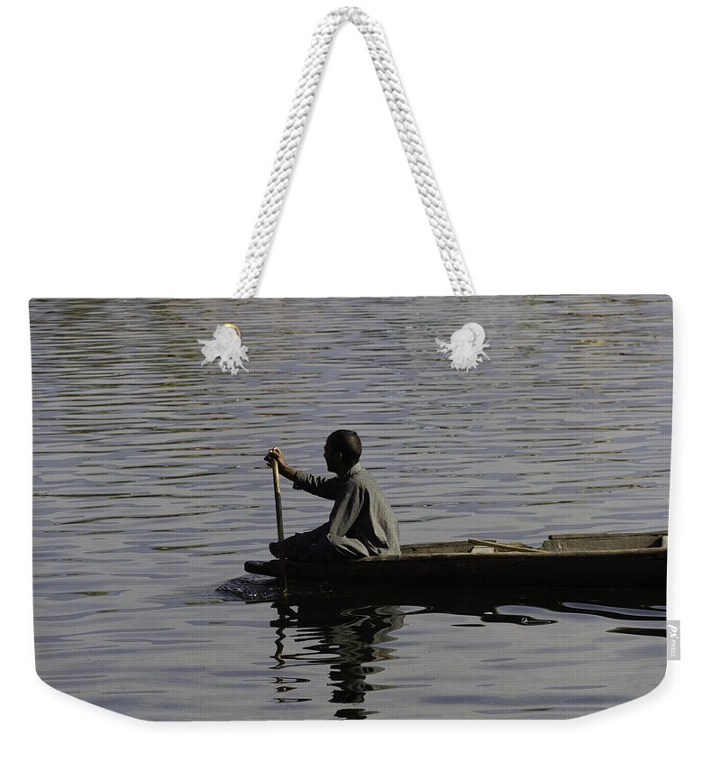Beautiful Scene Weekender Tote Bag featuring the photograph Splashing in the water caused due to Kashmiri man rowing a small boat by Ashish Agarwal
