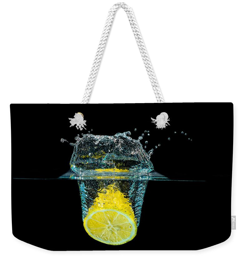 Beverage Weekender Tote Bag featuring the photograph Splashing Lemon by Peter Lakomy