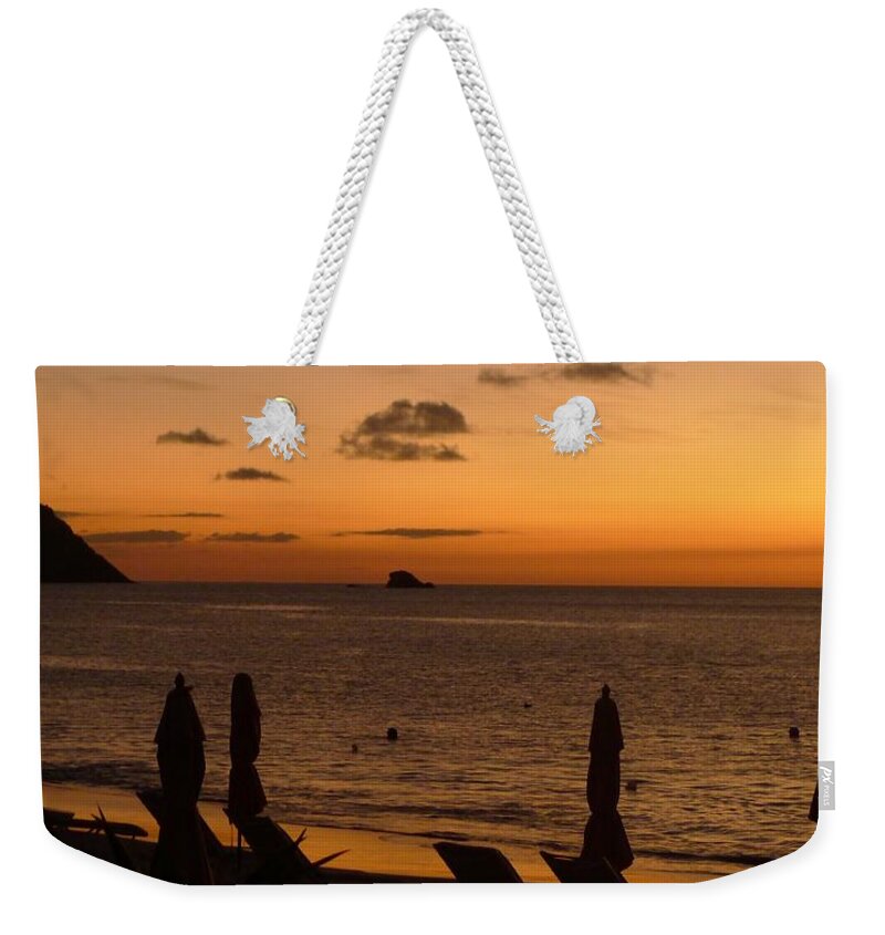  Weekender Tote Bag featuring the photograph St. Lucia - Sundown - Closed Umbrellas by Nora Boghossian