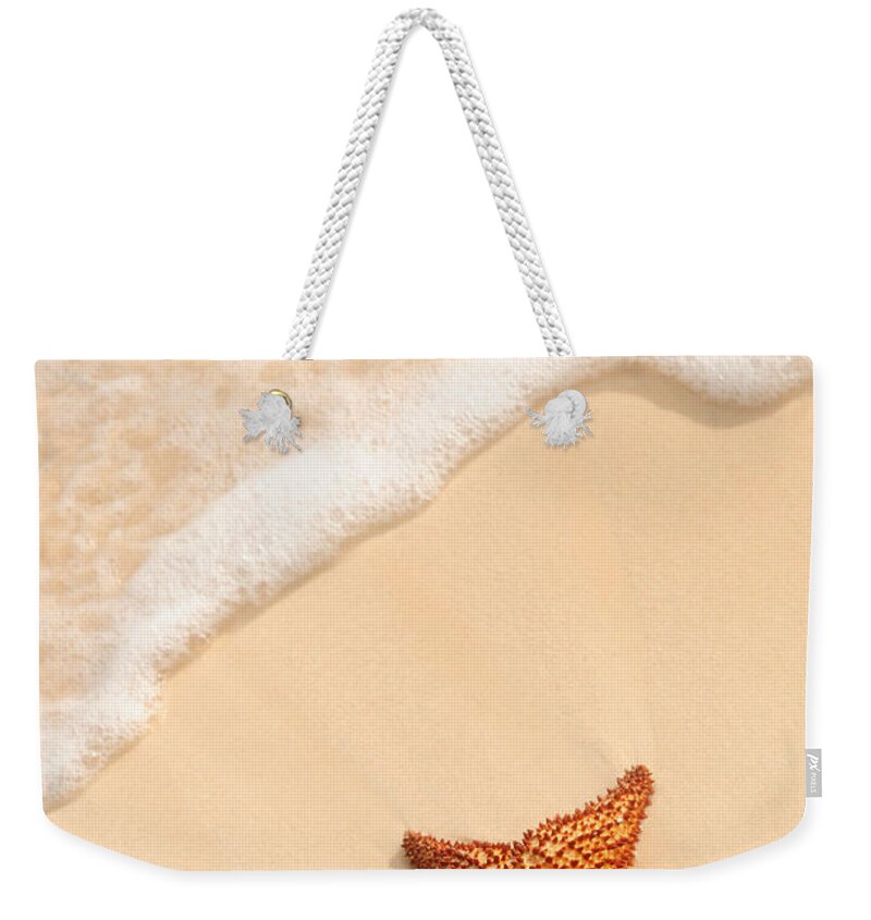 Starfish Weekender Tote Bag featuring the photograph Starfish and ocean wave by Elena Elisseeva