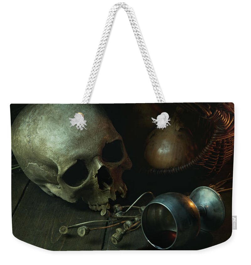 Still Life Weekender Tote Bag featuring the photograph Still life with human skull and silver chalice by Jaroslaw Blaminsky
