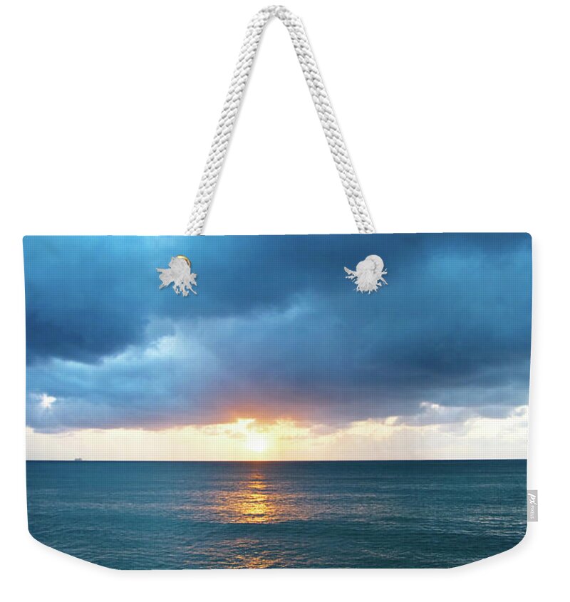 Water's Edge Weekender Tote Bag featuring the photograph Stormy Clouds Seascape At Sunset by Jaminwell