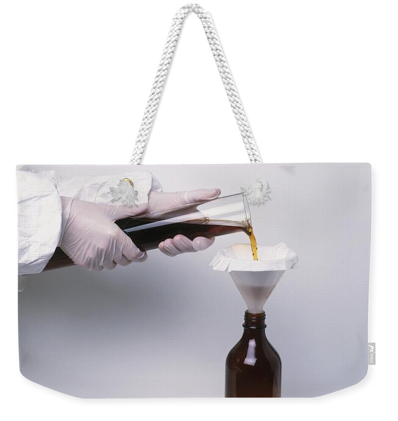 Adult Weekender Tote Bag featuring the photograph Straining Herbal Infusion by Dorling Kindersley