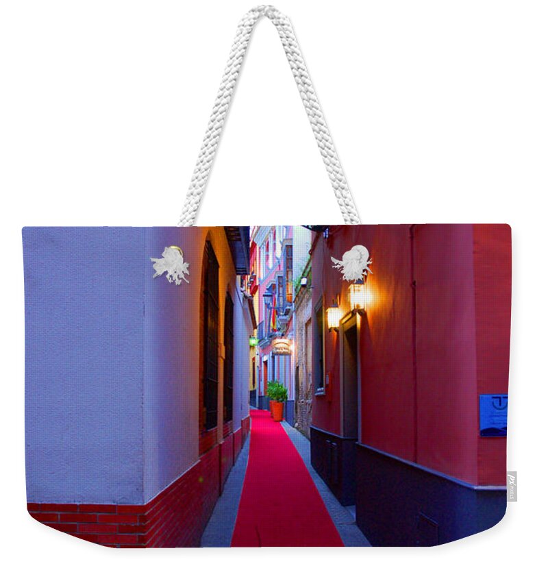 Seville Weekender Tote Bag featuring the photograph Streets of Seville - Red Carpet by AM FineArtPrints