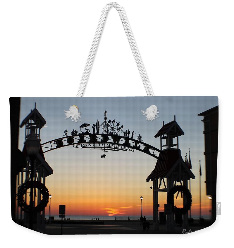 Sunrise Weekender Tote Bag featuring the photograph Sun Reflecting on Clouds Ocean City Boardwalk Arch by Robert Banach