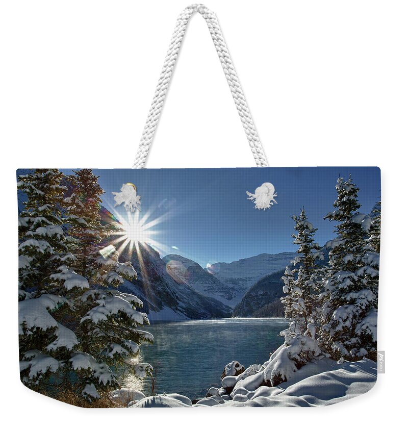 Tranquility Weekender Tote Bag featuring the photograph Sun Rises Above Mountain Lake, Winter by Ascentxmedia
