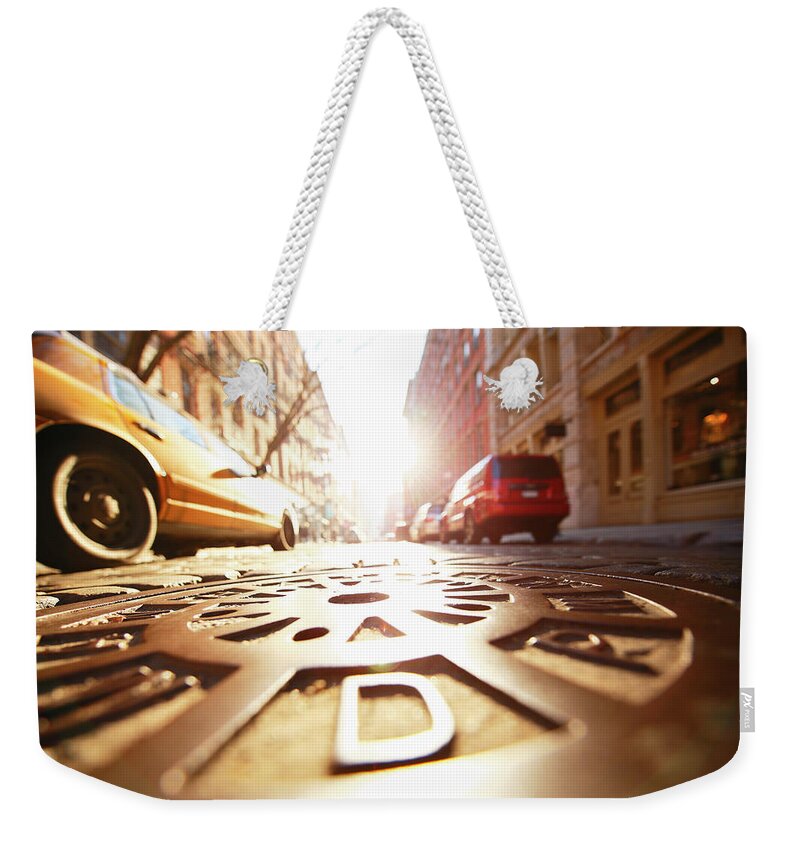 Outdoors Weekender Tote Bag featuring the photograph Sun Shining Manhole At Soho Stone by Toshi Sasaki