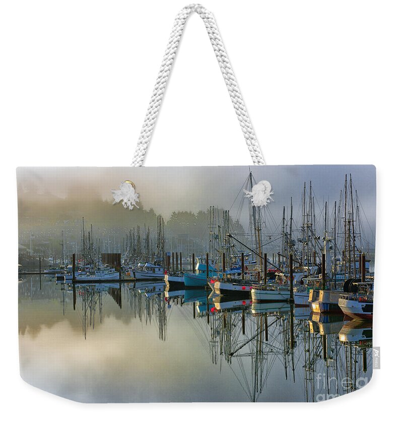 Harbor;sunrise;boats;fog;mist;clouds;reflection;reflections;harbors;newport;oregon;pacific;northwest;scenic;scenics;fishing;waterscape;waterscapes;sandra Bronstein;mirror;colorful;horizontal;morning;moody;fine;art;photography;canvas;prints;posters;greeting;cards;notecards;iconic;tourism;travel;port;seaport;acrylic;photographs; Weekender Tote Bag featuring the photograph Sunrise At Newport Harbor by Sandra Bronstein