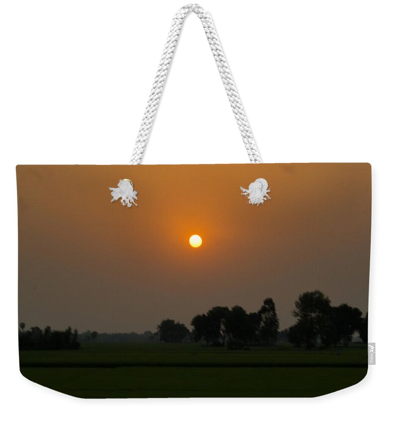 Sunset Weekender Tote Bag featuring the photograph Sunset over the farm by SAURAVphoto Online Store