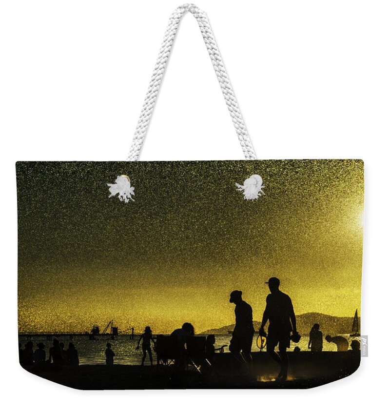 Back Lit Weekender Tote Bag featuring the photograph Sunset silhouette of people at the beach by Peter V Quenter