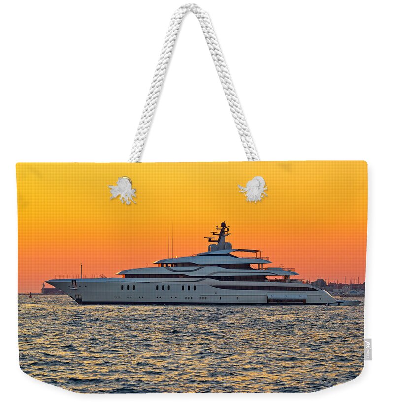 Vessel Weekender Tote Bag featuring the photograph Superyacht on yellow sunset view by Brch Photography