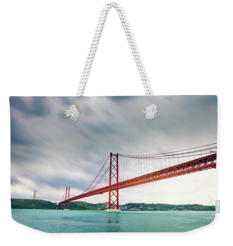 Scenics Weekender Tote Bag featuring the photograph Suspension Bridge Over The River by Leopatrizi
