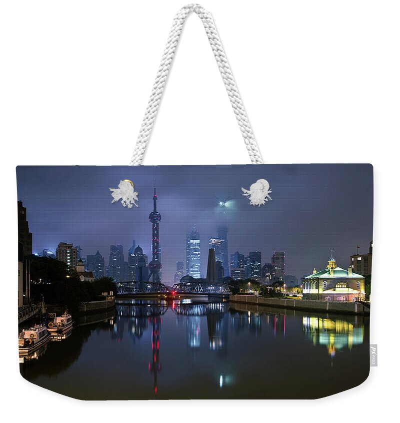 Tranquility Weekender Tote Bag featuring the photograph Suzhou Creek With Shanghai Skyline At by Spreephoto.de