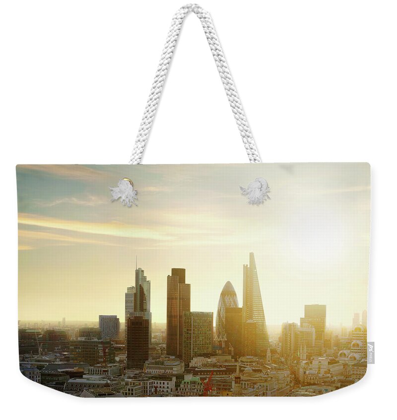 City Weekender Tote Bag featuring the photograph The City Of London With Sun by Tim Robberts