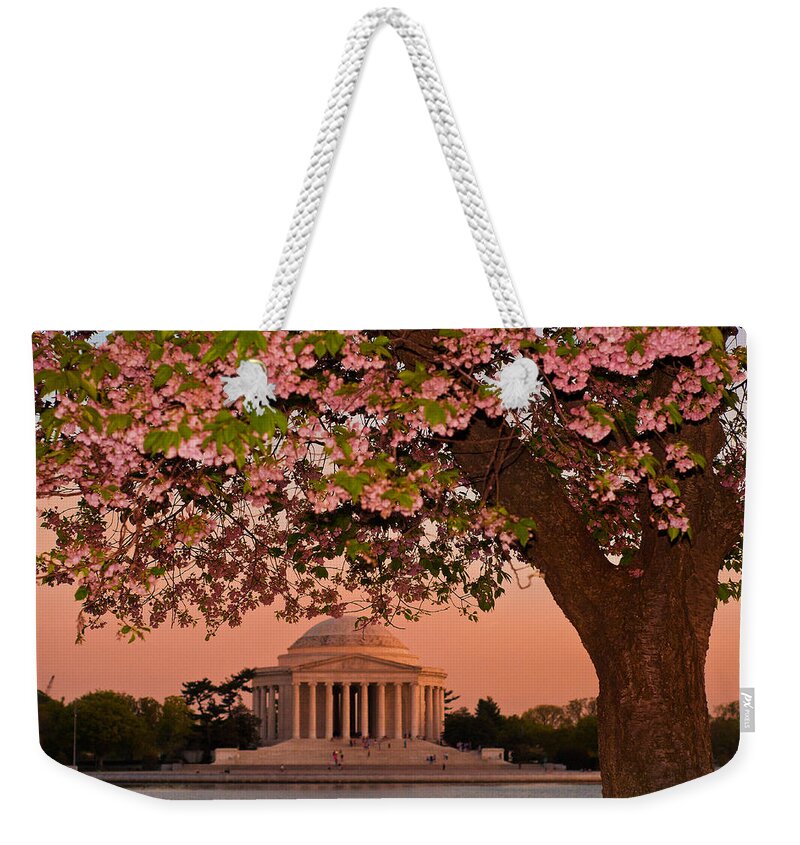 America Weekender Tote Bag featuring the photograph The Jefferson Memorial Framed by a Cherry Tree by Mitchell R Grosky