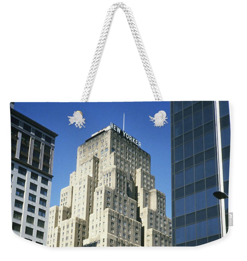 New Yorker Weekender Tote Bag featuring the photograph The New Yorker Hotel in 1984 by Gordon James