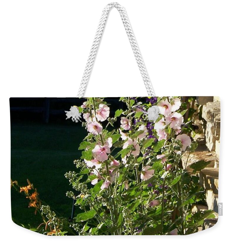 Hollyhocks Weekender Tote Bag featuring the photograph The Secret Garden by Jackie Mueller-Jones