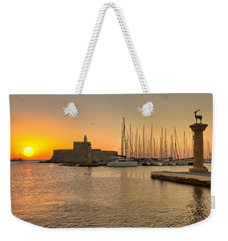 Aegean Weekender Tote Bag featuring the photograph The sunrise at the old port of Rhodes - Greece by Constantinos Iliopoulos
